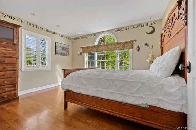 a bed sitting in a bedroom next to a window