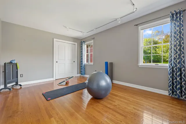 a bedroom with a bed and a wooden floor