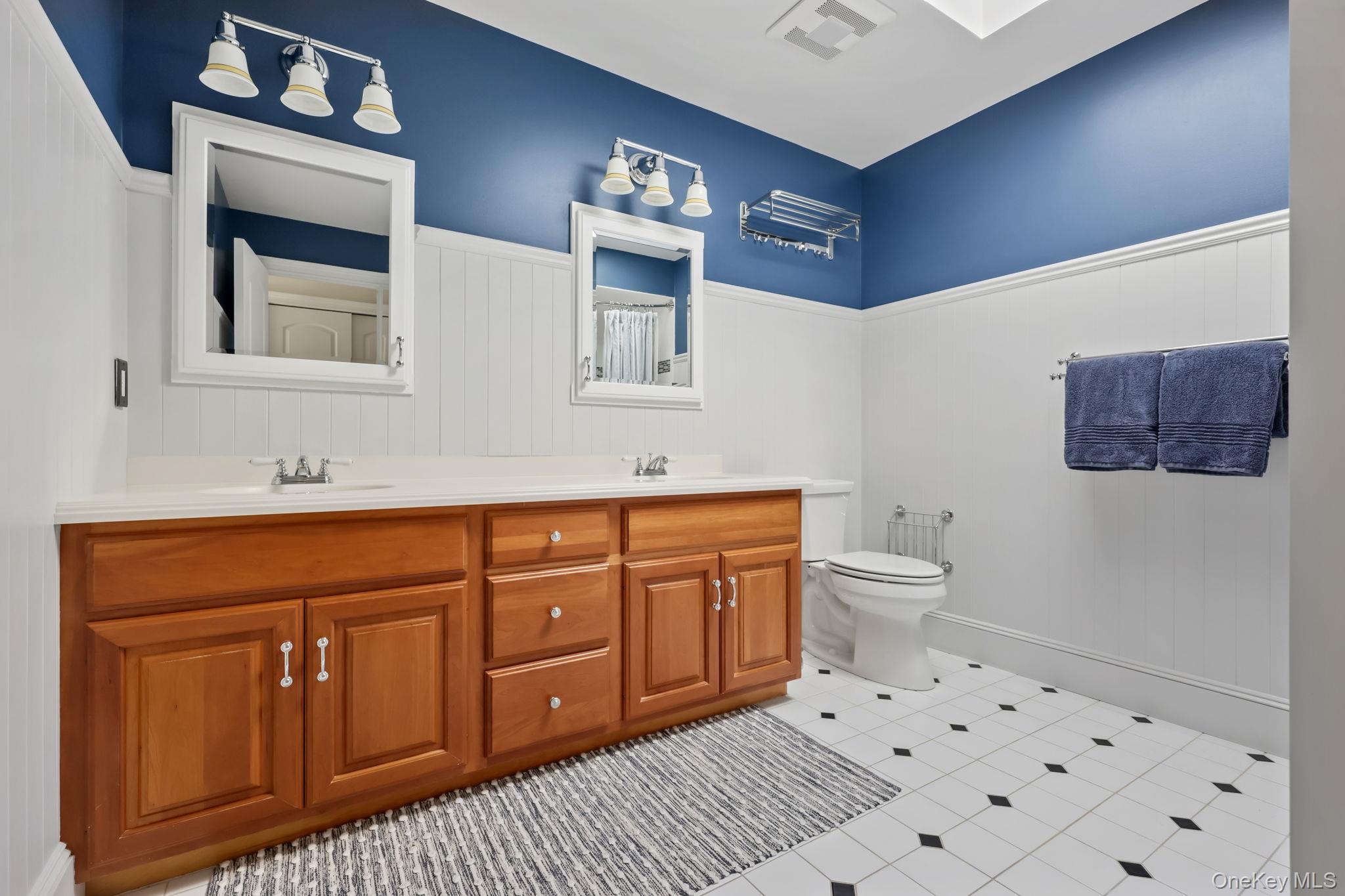 21 Adams Farm Road Katonah, NY 10536 - Photo 27 of 47 a spacious bathroom with a sink a toilet and a mirror