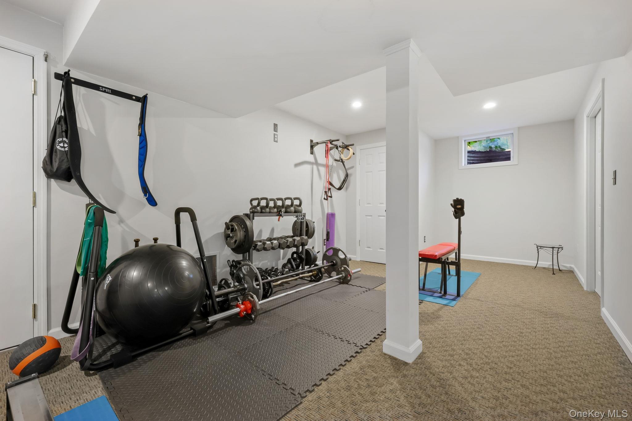 21 Adams Farm Road Katonah, NY 10536 - Photo 35 of 47 a room with gym equipment and mirror