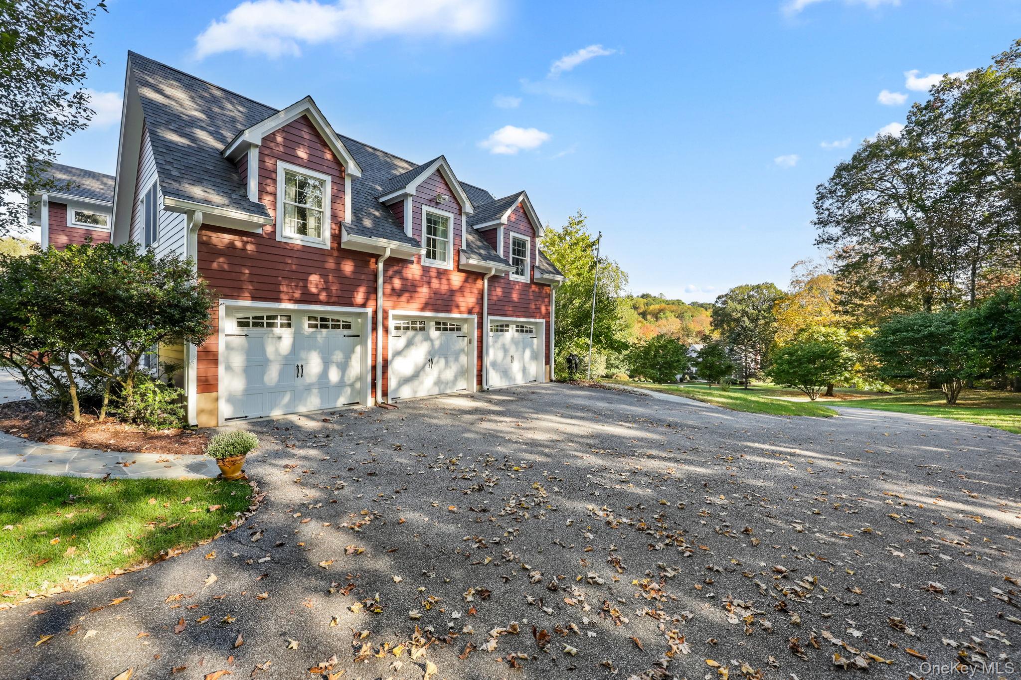 21 Adams Farm Road Katonah, NY 10536 - Photo 36 of 47 a front view of a house with a yard and garage