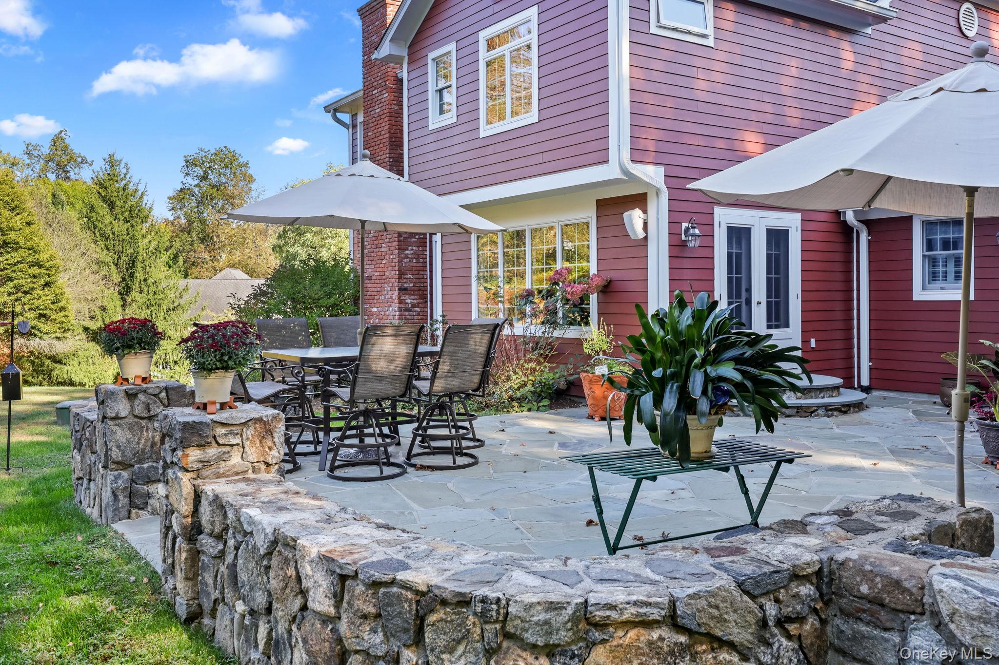 21 Adams Farm Road Katonah, NY 10536 - Photo 38 of 47 a view of a patio with table and chairs under an umbrella