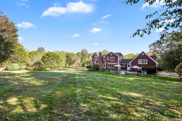 a aerial view of a house with a big yard and large trees