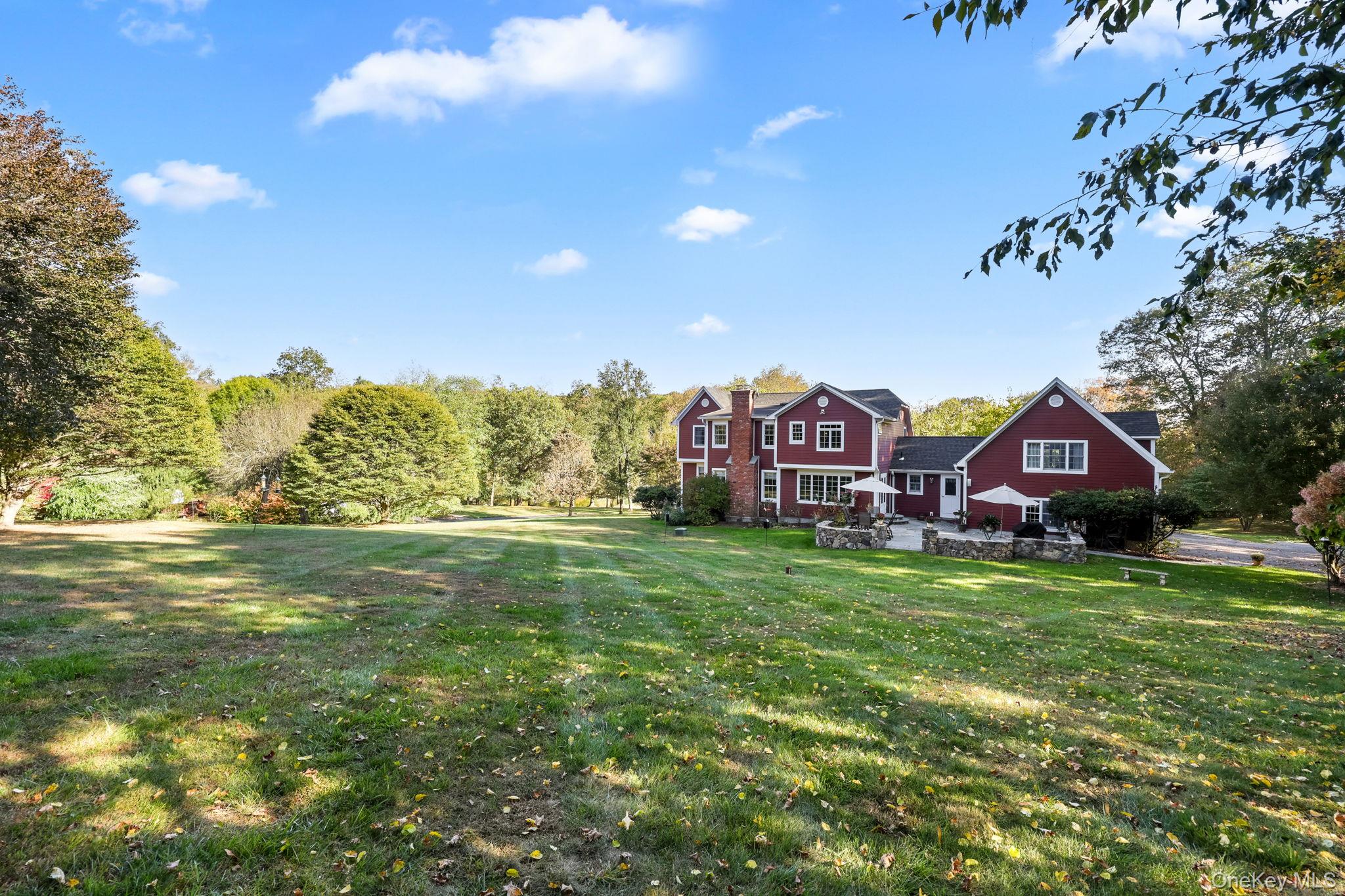 21 Adams Farm Road Katonah, NY 10536 - Photo 42 of 47 a aerial view of a house with a big yard and large trees