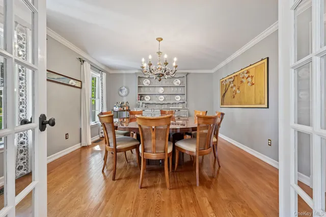 a dining room with furniture a chandelier and wooden floor