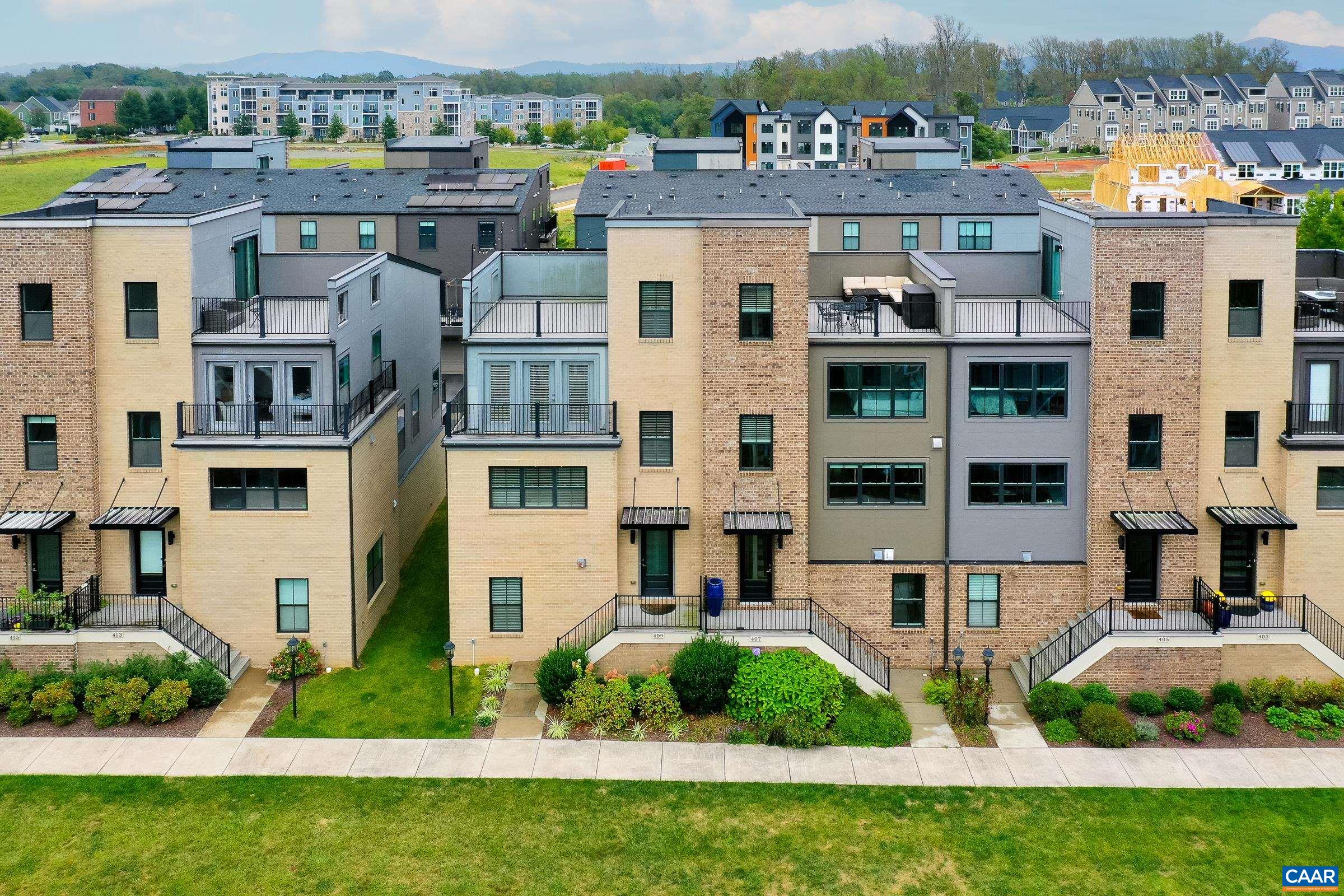 Beautiful modern townhome in the heart of Old Trail is walkable to shops and restaurants with common green space in front of the home.