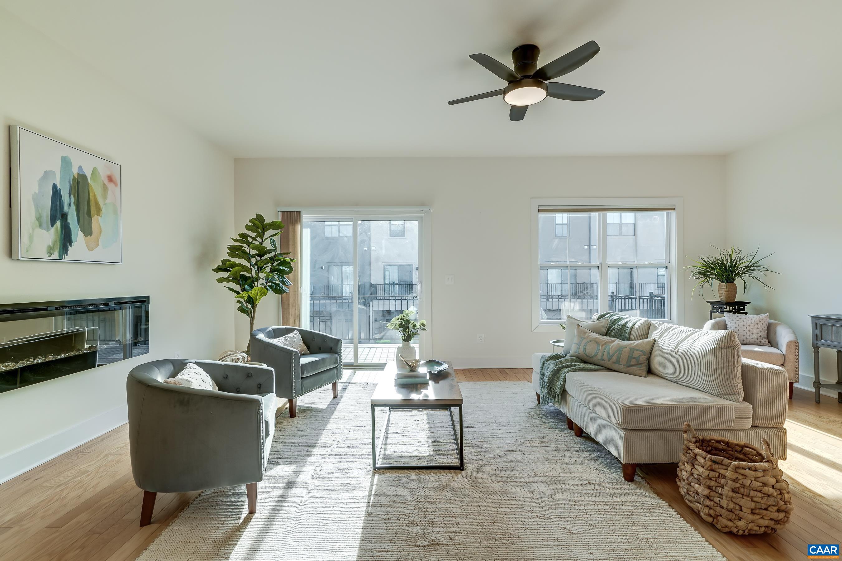 407 Fennel Road Crozet, VA 22932 - Photo 14 of 54 Living room features a ceiling fan and electric fireplace.