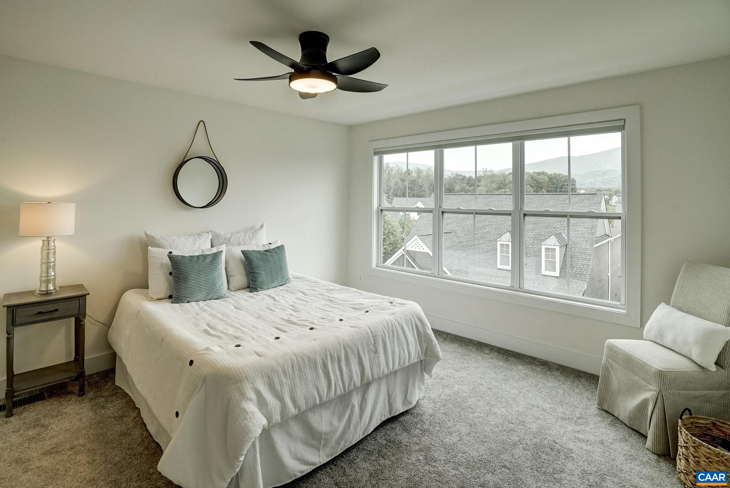 407 Fennel Road Crozet, VA 22932 - Photo 22 of 54 Spacious primary suite features ceiling fan, ensuite bathroom, and large walk in closet.