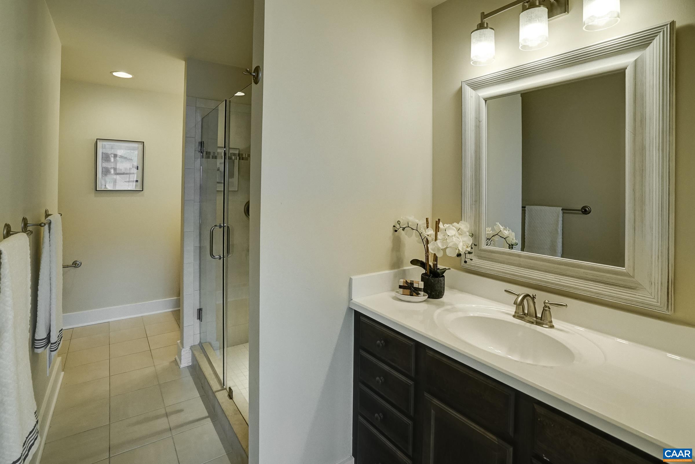 407 Fennel Road Crozet, VA 22932 - Photo 24 of 54 Primary bathroom features two separate vanities, and a tiled shower with frameless glass sliding door.
