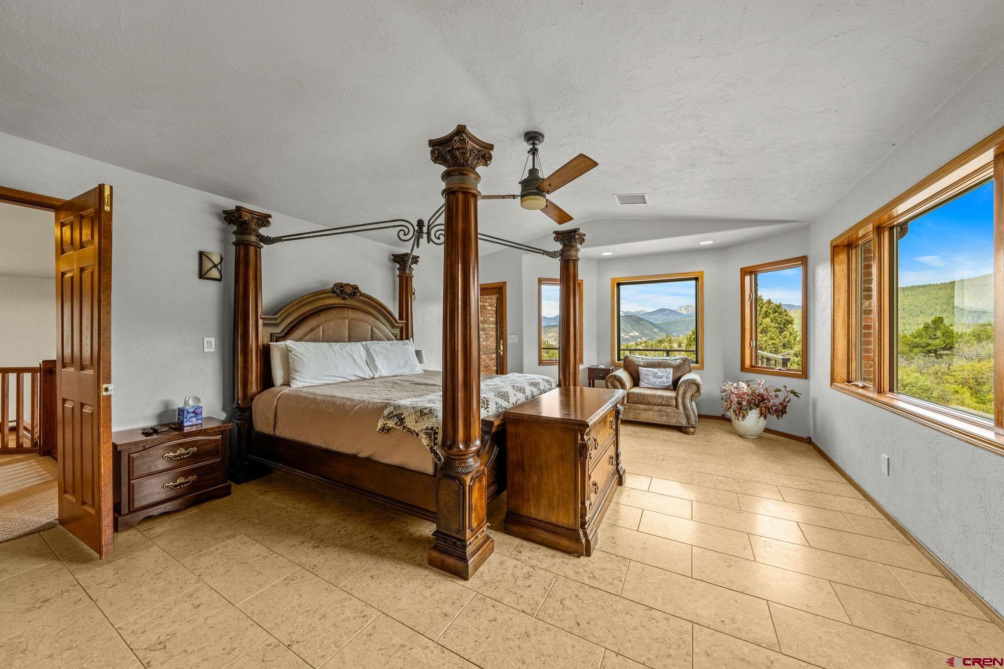 201 Ute Canyon Road Durango, CO 81301 - Photo 15 of 44 a bedroom with furniture and large windows