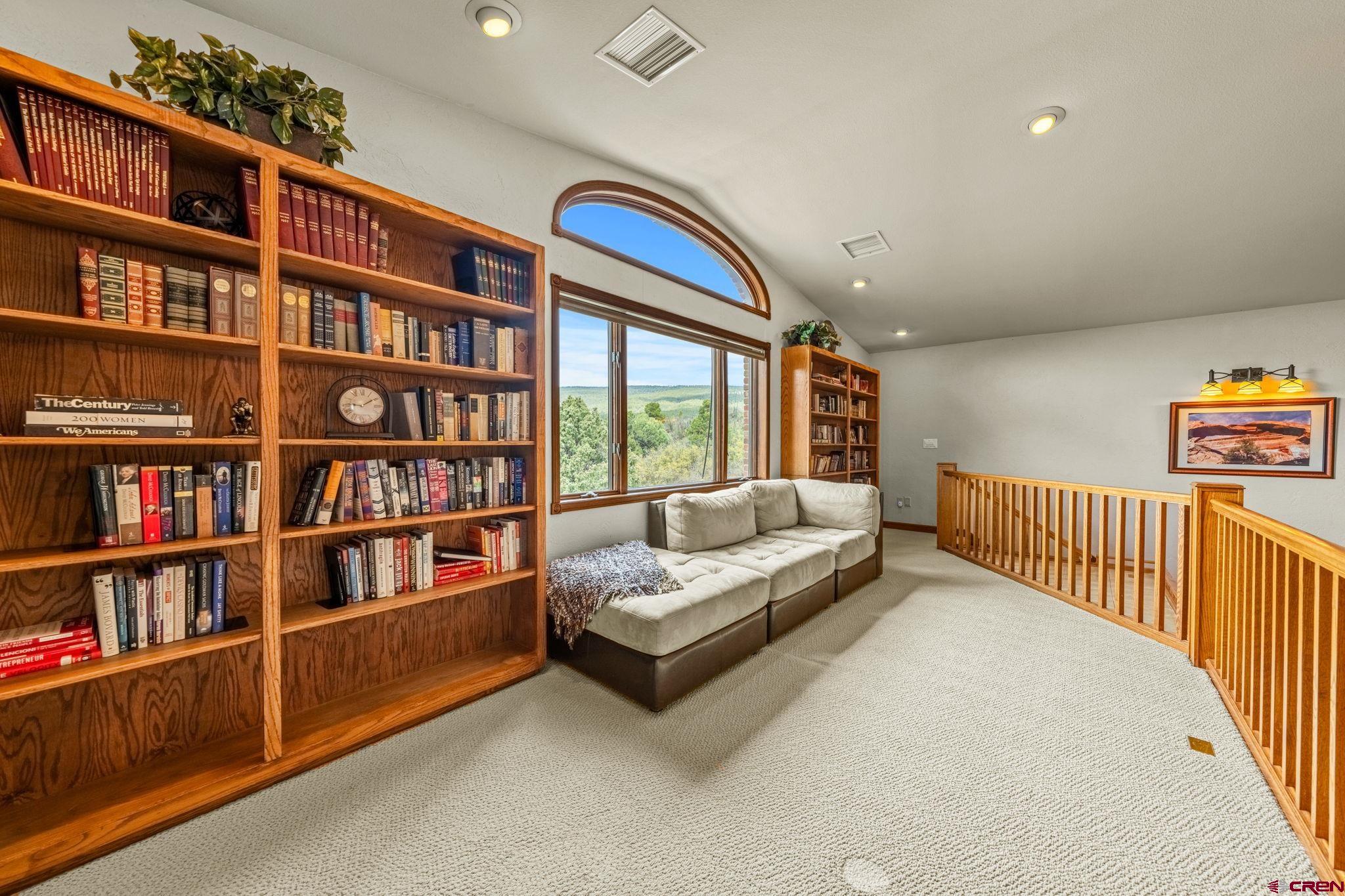 201 Ute Canyon Road Durango, CO 81301 - Photo 15 of 44 a living room with furniture and a book shelf