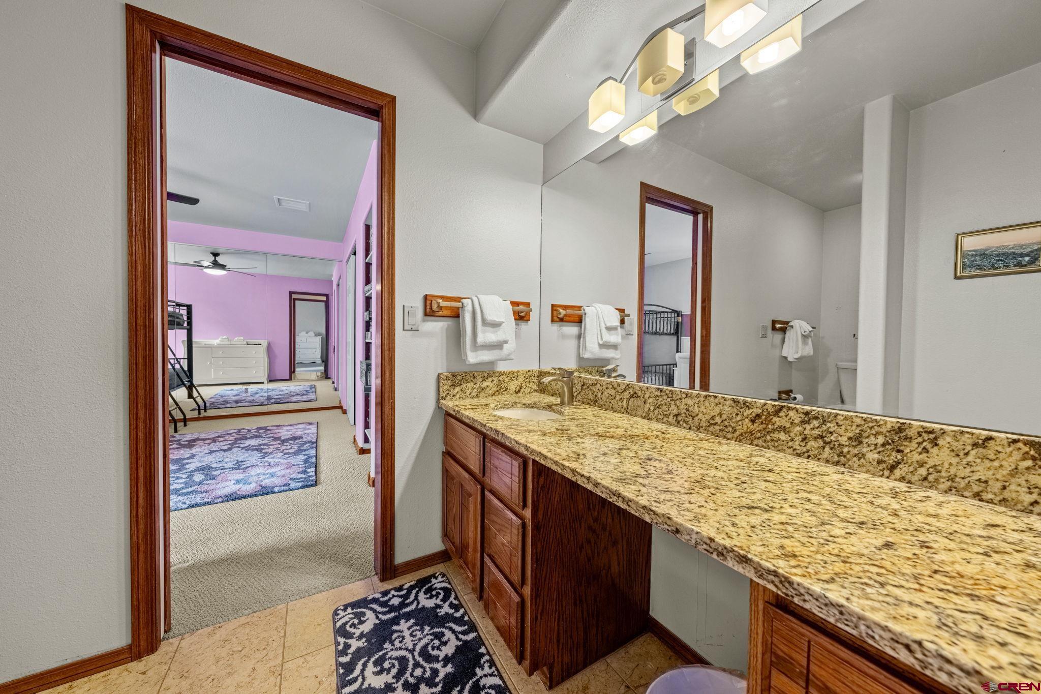 201 Ute Canyon Road Durango, CO 81301 - Photo 19 of 44 a bathroom with a granite countertop sink and a mirror