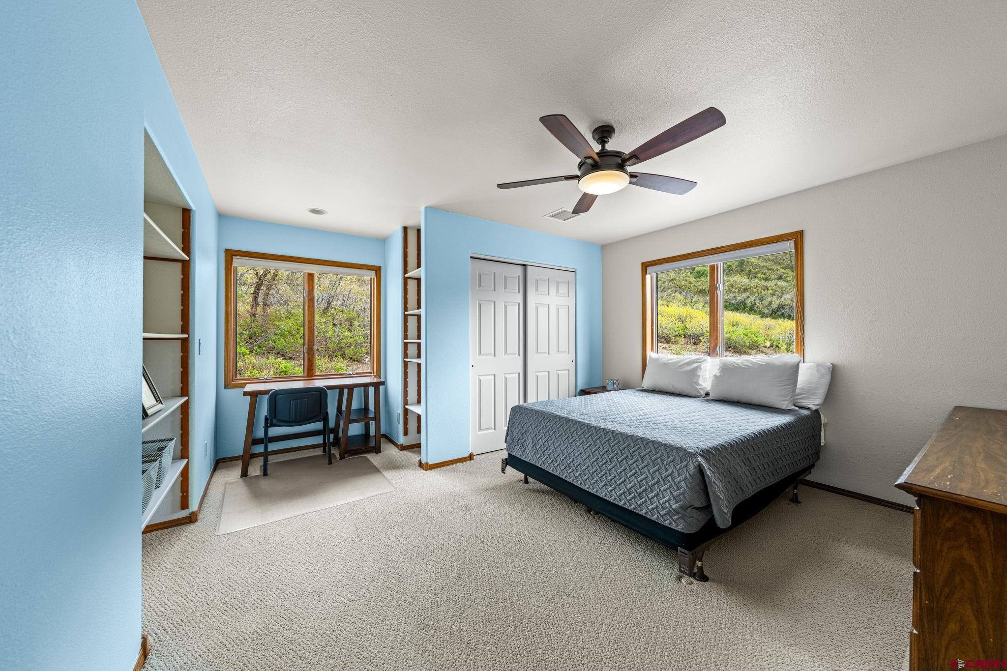 201 Ute Canyon Road Durango, CO 81301 - Photo 20 of 44 a living room with a bed furniture and a window