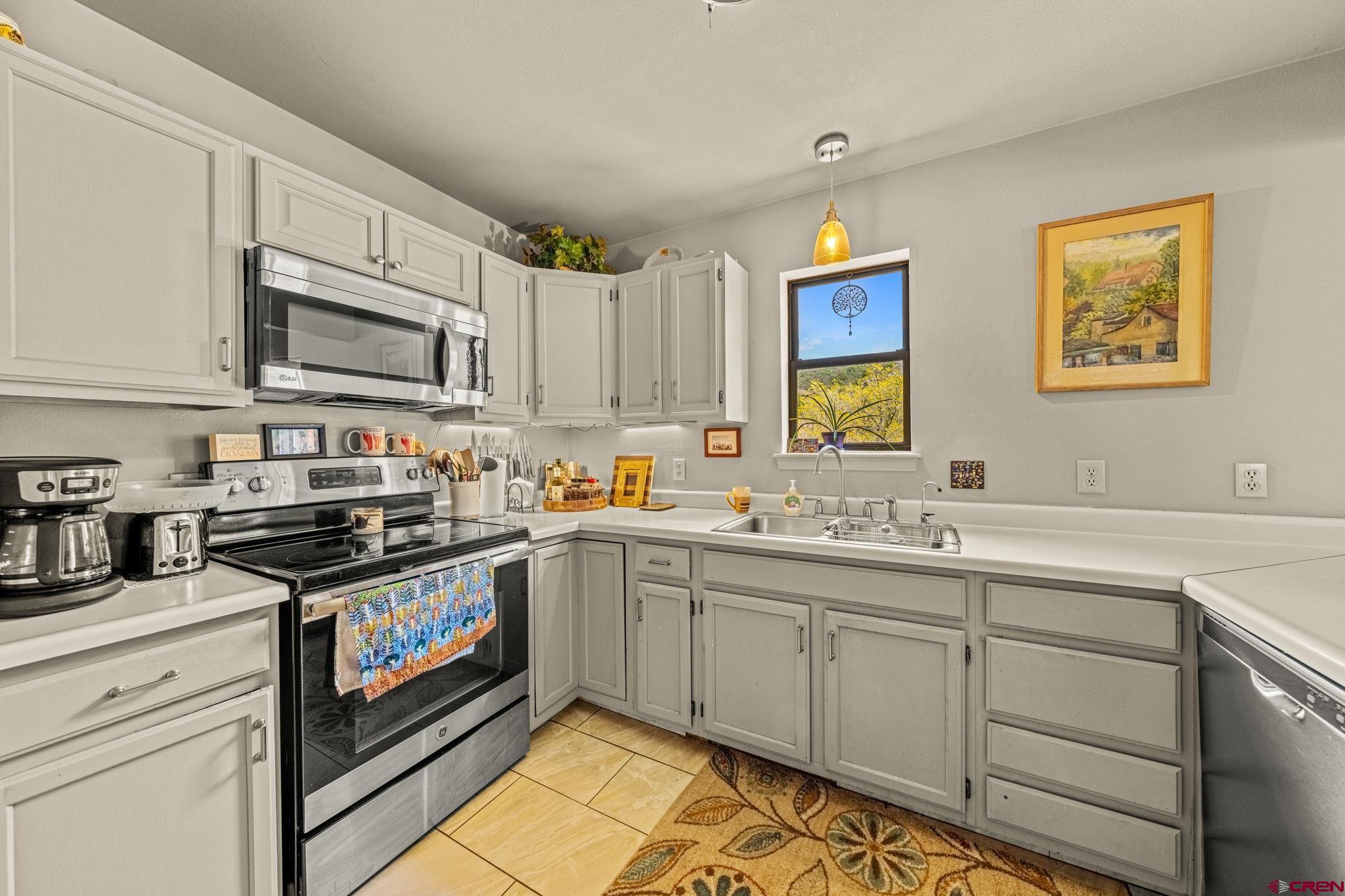 201 Ute Canyon Road Durango, CO 81301 - Photo 23 of 44 a kitchen with stainless steel appliances granite countertop a stove and cabinets