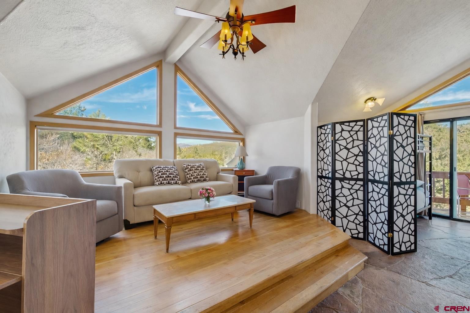 201 Ute Canyon Road Durango, CO 81301 - Photo 26 of 44 a living room with furniture a window and a chandelier