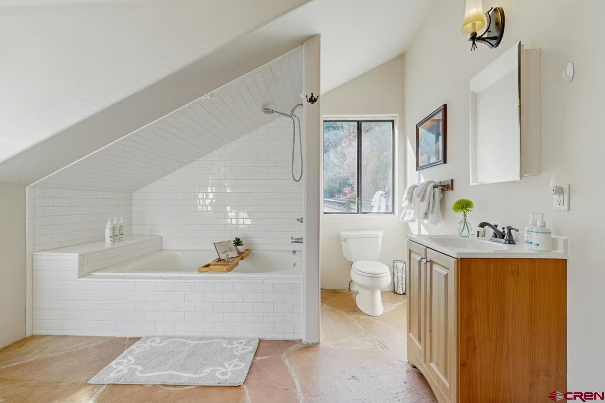 201 Ute Canyon Road Durango, CO 81301 - Photo 42 of 44 a living room with furniture and a lamp