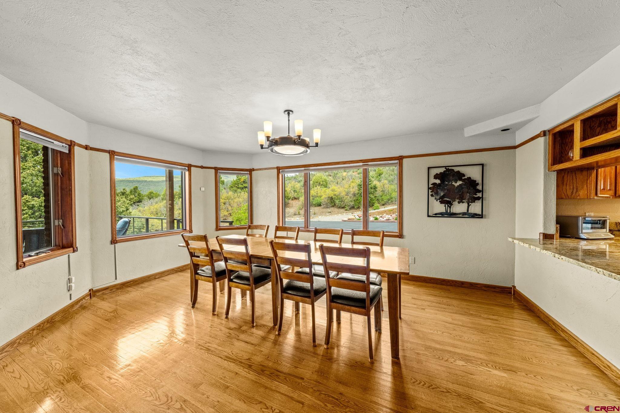201 Ute Canyon Road Durango, CO 81301 - Photo 7 of 44 a view of a dining room with furniture window and wooden floor