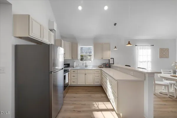 a kitchen with a refrigerator sink and stove