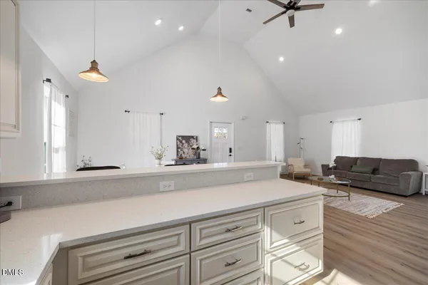 a living room with furniture and a ceiling fan