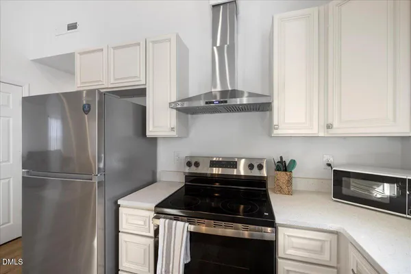 a kitchen with appliances and cabinets