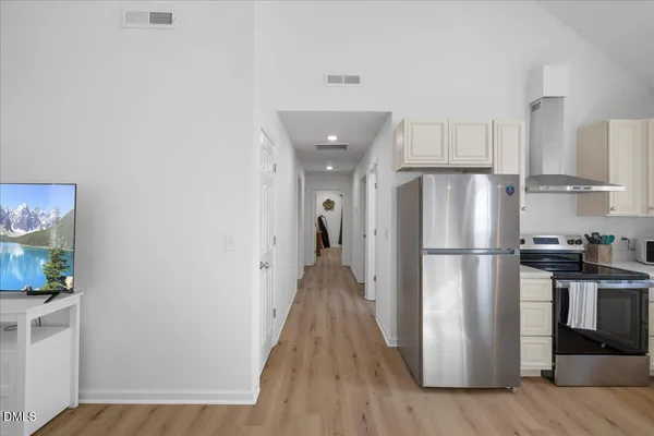 a kitchen with a refrigerator a stove top oven a sink and dishwasher