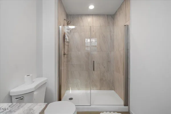 a bathroom with a shower a toilet and a sink