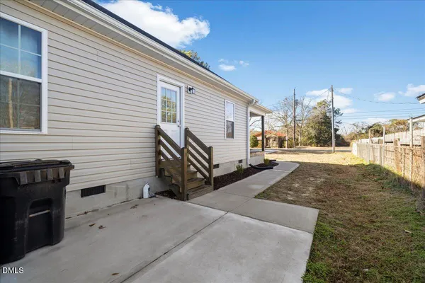a view of a house with backyard and a trees