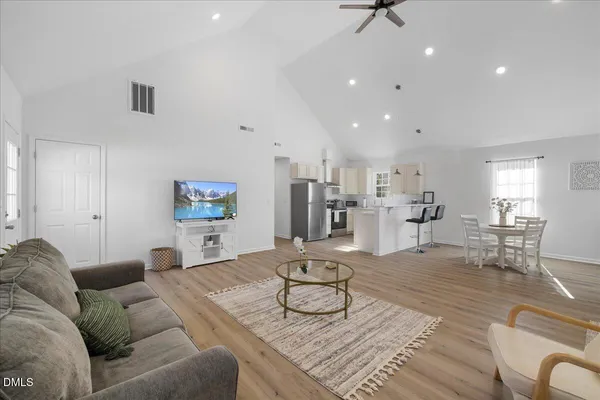 a living room with furniture and kitchen view