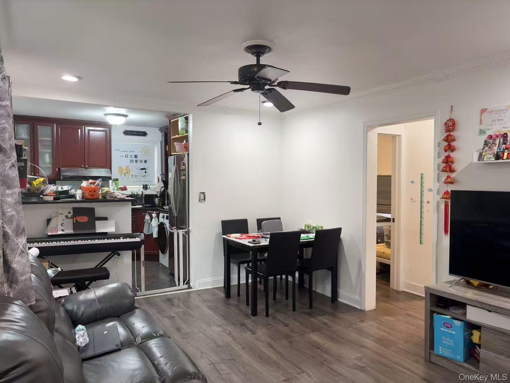 67-60 224 Street, Unit 6760A Queens, NY 11364 - Photo 3 of 12 a view of a dining room with furniture and wooden floor