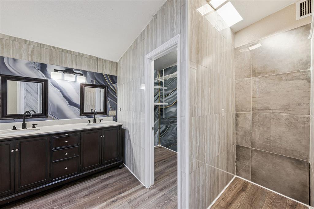 219 Bennett Street Winter Springs, FL 32708 - Photo 11 of 26 a spacious bathroom with a double vanity sink a large mirror and shower