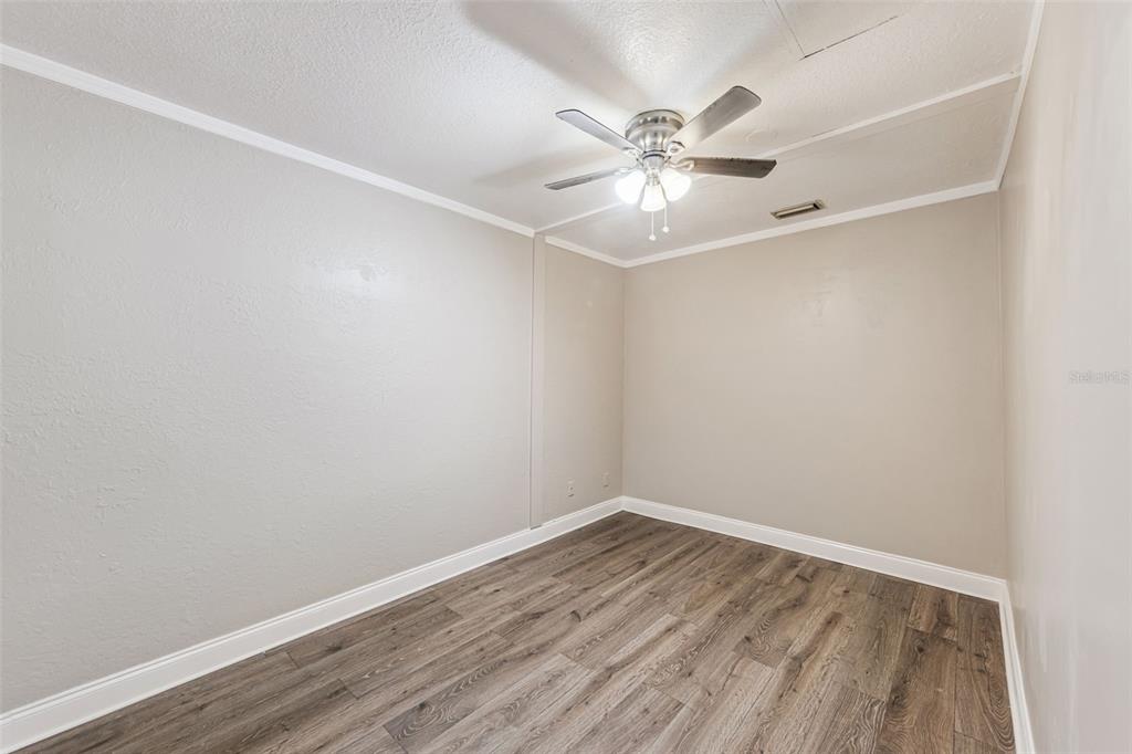 219 Bennett Street Winter Springs, FL 32708 - Photo 19 of 26 an empty room with wooden floor and fan