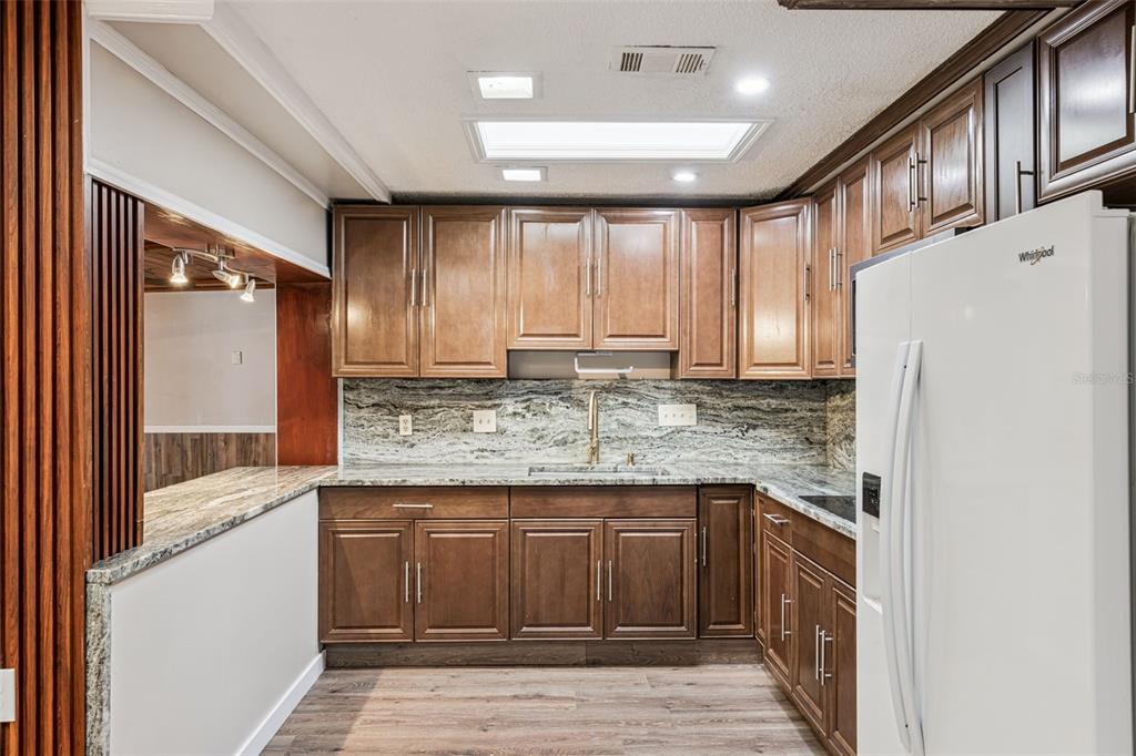 219 Bennett Street Winter Springs, FL 32708 - Photo 9 of 26 a kitchen with a stove a refrigerator and a sink