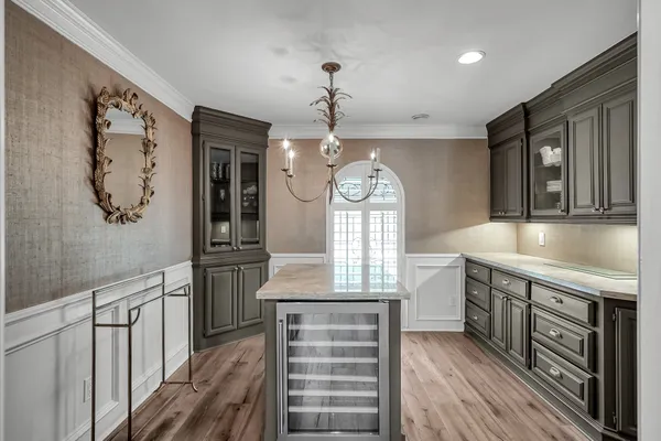 a spacious bedroom with furniture and a large window