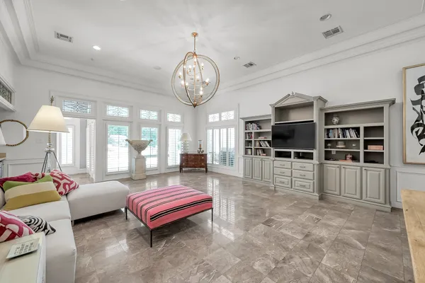 a living room with furniture and a chandelier