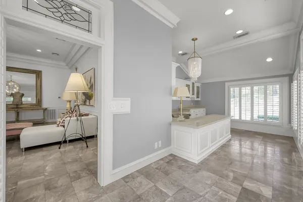 a large white kitchen with a large window