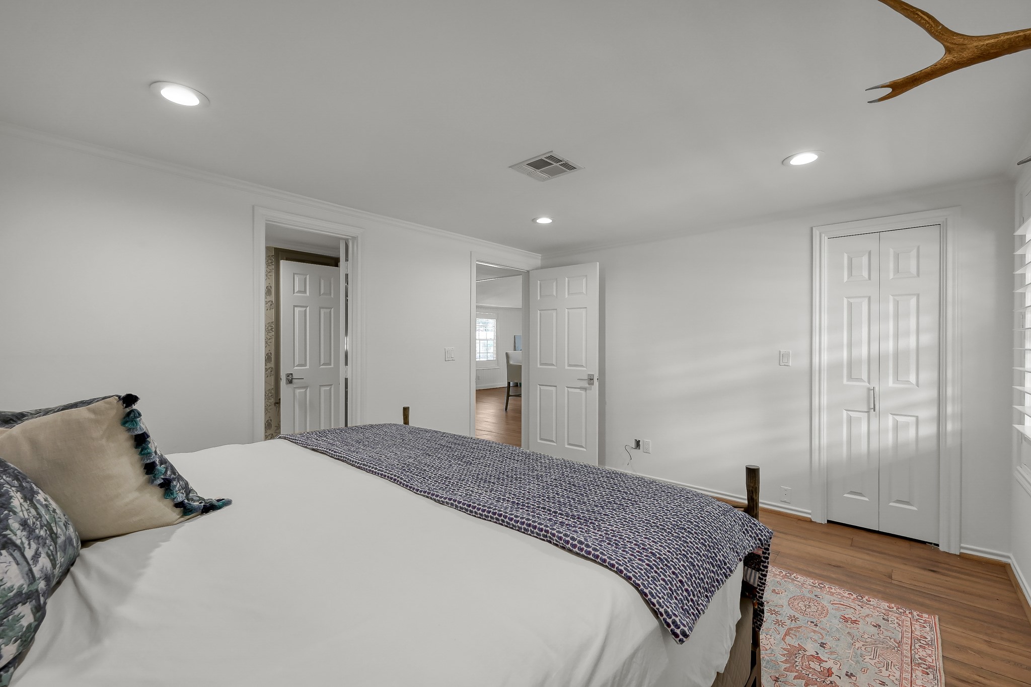 3272 Teas Nursery Road Conroe, TX 77304 - Photo 38 of 50 a bedroom with a large bed and wooden floor