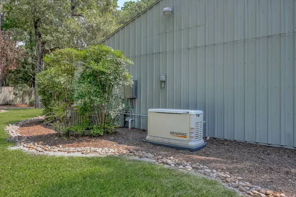 an aerial view of residential house with outdoor space and covered with green space