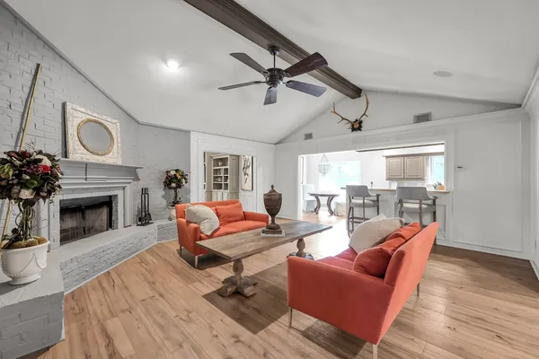 a living room with fireplace furniture and a flat screen tv