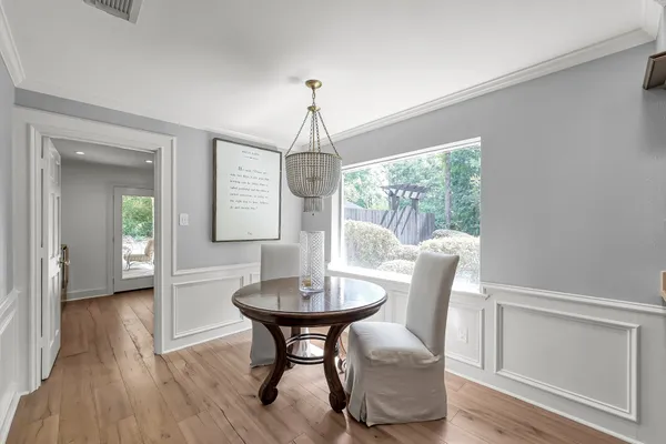 a large kitchen with a lot of counter space and wooden floor