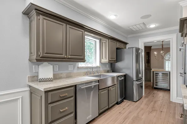 a view of a kitchen area with furniture and wooden floor