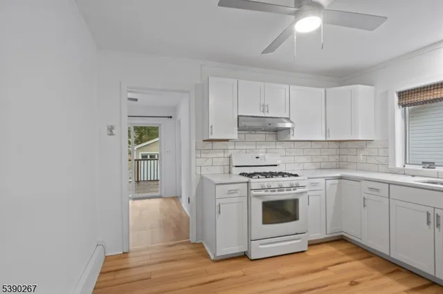 a kitchen with a stove oven and sink