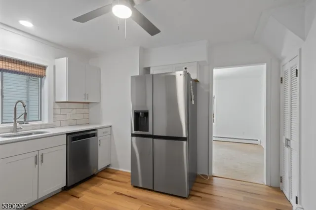 a kitchen with a refrigerator sink and cabinets