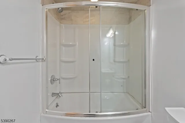 a bathroom with a glass shower door