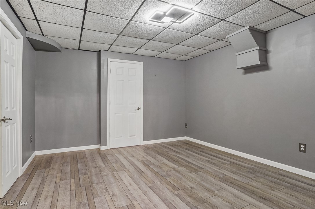 370 Wilcox Road Youngstown, OH 44515 - Photo 38 of 49 Finished basement featuring a drop ceiling and wood finished floors