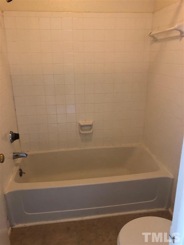 2506 Avent Ferry Road, Unit 203 Raleigh, NC 27606 - Photo 13 of 13 a bathroom with a bathtub and a shower