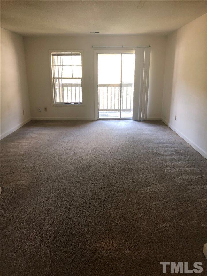 2506 Avent Ferry Road, Unit 203 Raleigh, NC 27606 - Photo 5 of 13 an empty room with a empty space and windows