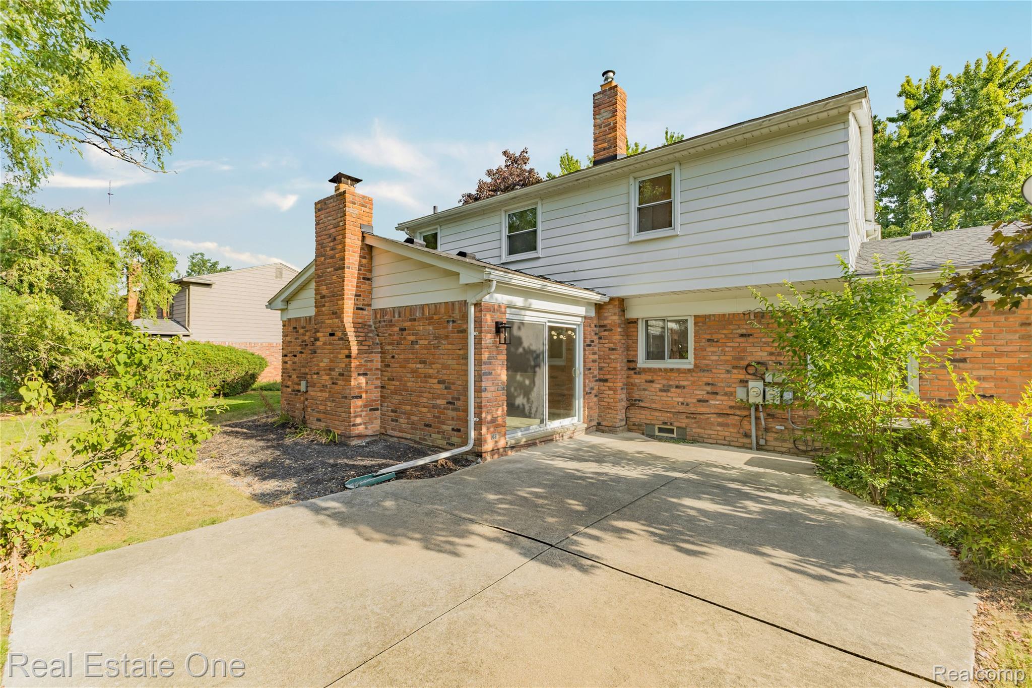 25695 Branchaster Road Farmington, MI 48336 - Photo 56 of 58 Brick and siding exterior with multiple windows and a sliding glass door
