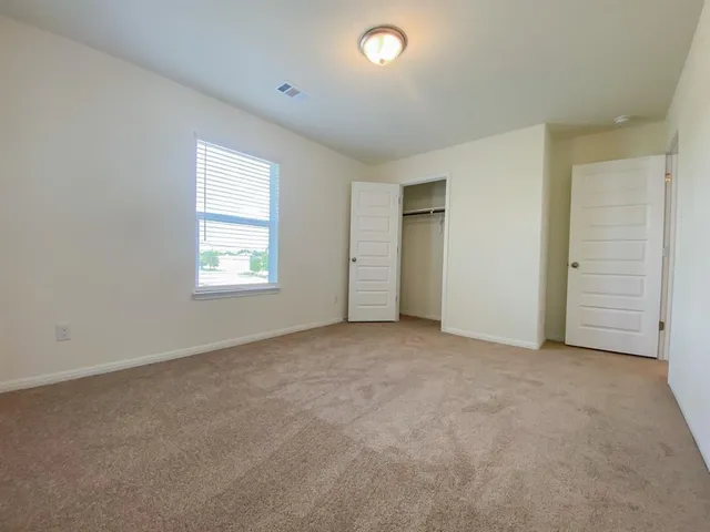 a bathroom with a sink a toilet and a large mirror