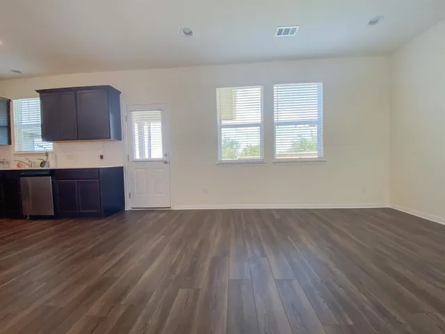 a kitchen with stainless steel appliances granite countertop wooden cabinets a refrigerator and a stove