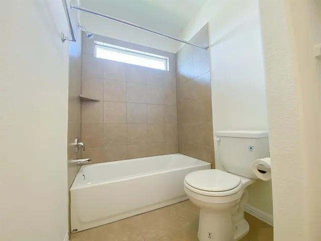 a bathroom with a toilet and a bathtub